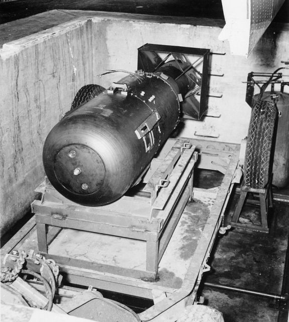 Little Boy in the bomb pit on Tinian Island, before being loaded into Enola Gay‘s bomb bay. A section of the bomb bay door is visible on the top right.