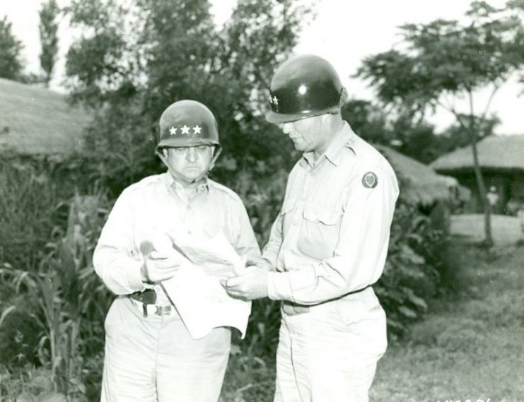 Lt. General Walton H. Walker, Commander, U.S. Eighth Army (left), and Major General William F. Dean, Commander, 24th Infantry Division, examine a map near the front lines somewhere in Korea.