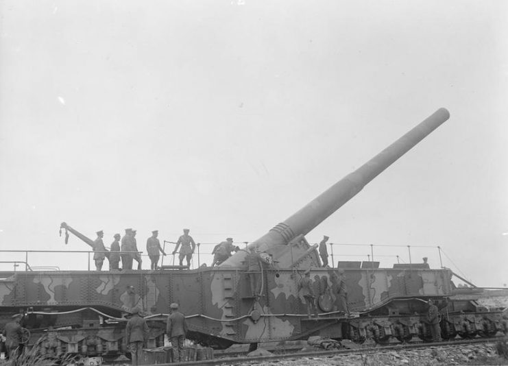 King George V inspects the breech of a 14 inch gun.