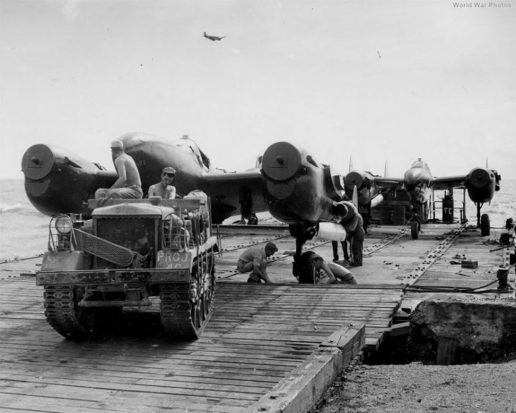 M2 Cletrac pulls P-38 off barge, Manila, May 1945.