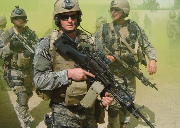 Petty Officer Second Class (SEAL) Michael A. Monsoor patrols the streets of Iraq while deployed in 2006. He received the Medal of Honor posthumously in a ceremony at the White House April 8, 2008.