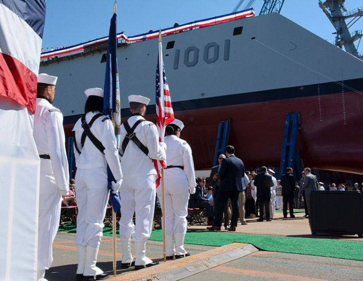 Crewmembers assigned to USS Constitution prepare to perform a color guard detail at the christening ceremony for guided-missile destroyer USS Michael Monsoor (DDG 1001) in the General Dynamics Bath Iron Works shipyard.