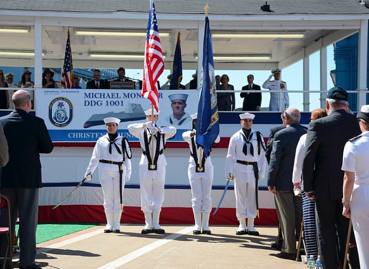 Crewmembers assigned to USS Constitution perform a color guard detail at the christening ceremony for guided-missile destroyer USS Michael Monsoor (DDG 1001) in the General Dynamics Bath Iron Works shipyard.