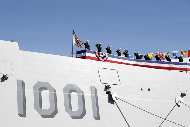 The crew of the Zumwalt-class guided-missile destroyer USS Michael Monsoor (DDG 1001) brings the ship to life during its commissioning ceremony, Jan. 26, 2019.