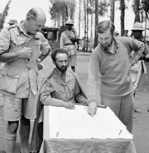 The Emperor of Abyssinia (modern day Ethiopia) with Brigadier Daniel Arthur Sandford on his left and Colonel Wingate on his right, in Dambacha Fort after it had been captured, 15 April 1941.