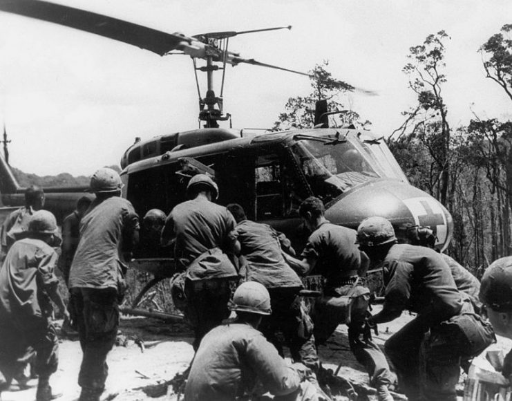 Wounded Soldiers are loaded on to a UH-1 medevac helicopter