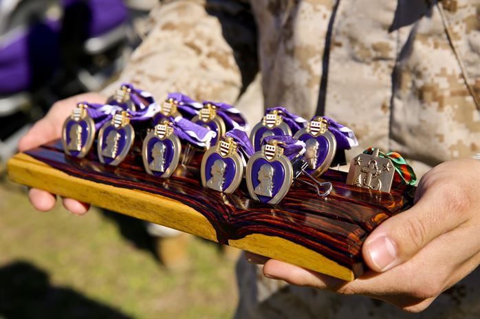 Purple Hearts being presented to Marines and a sailor,  2nd Battalion, 2nd Marine Regiment, in support of Operation Enduring Freedom October 24, 2013. (Official U.S. Marine Corps photo by Lance Cpl. Michael C. Dye)