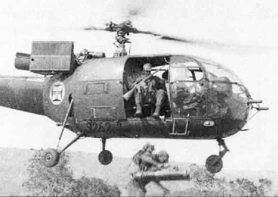 Portuguese páraquedistas armed with AR-10 rifles disembark from an Alouette III helicopter during the Angolan War of 1961-1974.