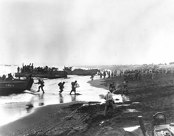 Soldiers unloading landing craft on the beach at Massacre Bay, Attu, on 12 May 1943.