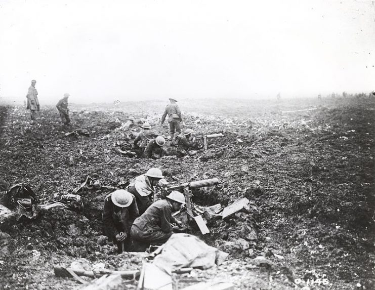 Canadian machine gunners dig themselves in, using shell holes as cover.