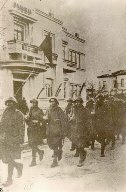 Greek Forces marching in the streets of Korce during the Greco-Italian War, November 1940.