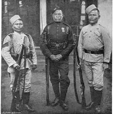 Gurkha soldiers (1896). The center figure wears the dark green dress uniform worn by all Gurkhas in British service, with certain regimental distinctions.