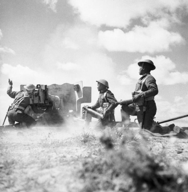 Gurkhas in action with a six-pounder anti-tank gun in Tunisia, 16 March 1943.