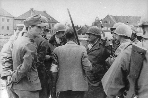 SS men confer with General Henning Linden during the capture of the Dachau concentration camp.