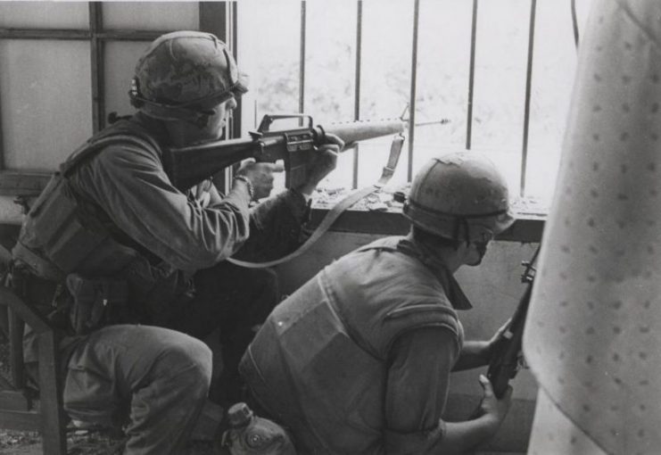 “Returning Fire: Marines A Company, 1st Battalion, 1st Marines [A/1/1] fire from a house window during a search and clear mission in the battle of Hue (official USMC photo by Sergeant Bruce A. Atwell).”
