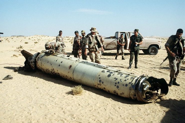 Military personnel examine the remains of a Scud during the Gulf War, May 26, 1992.