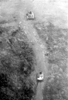 Photograph taken by U.S. Air Force reconnaissance aircraft showing 2 destroyed PT-76 tanks in Lang Vei
