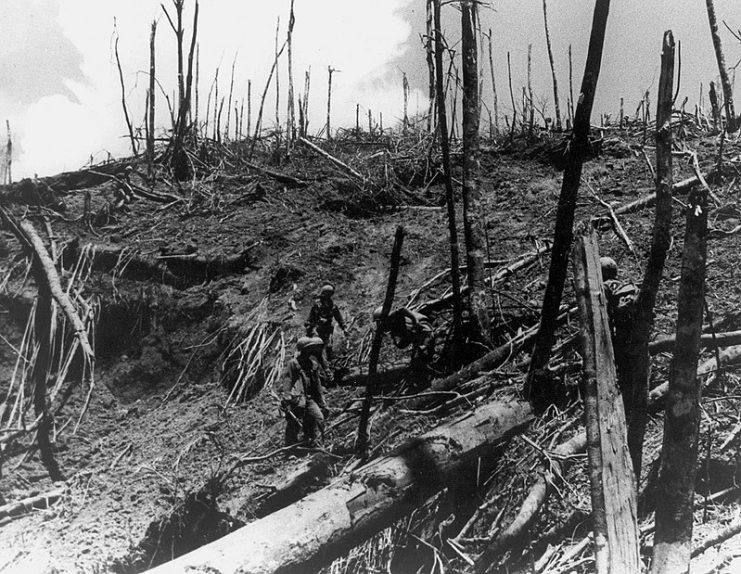Soldiers of the 101st Airborne Division inspect damage in the surrounding area of Dong Ap Bia during Operation Apache Snow, May 1969