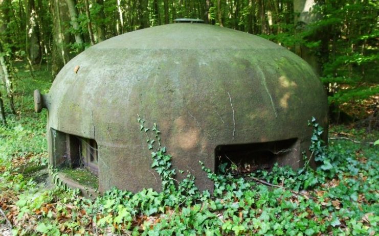 A machine-gun and observation turret of a Maginot Line fort deep in the forest