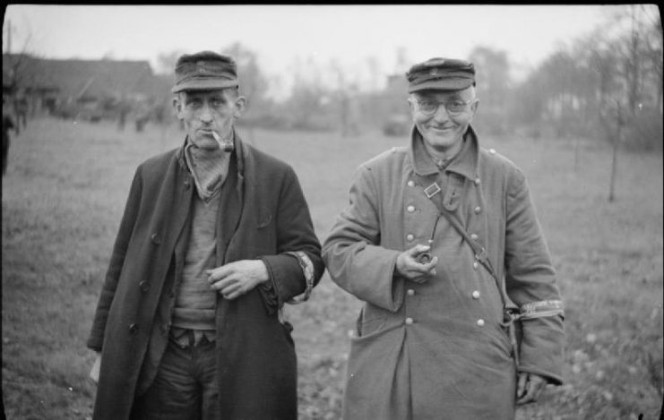 Two old members of the Volksturm seem relieved to have surrendered to British troops in Bocholt, 28 March 1945.