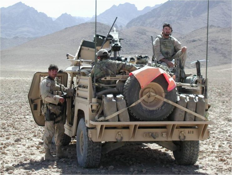 Tech. Sgt. Kevin Whalen (right) sitting on a Special Forces Humvee in Afghanistan. To his right is a Mk 19 automatic grenade launcher mounted on the vehicle. (U.S. Air Force photo)