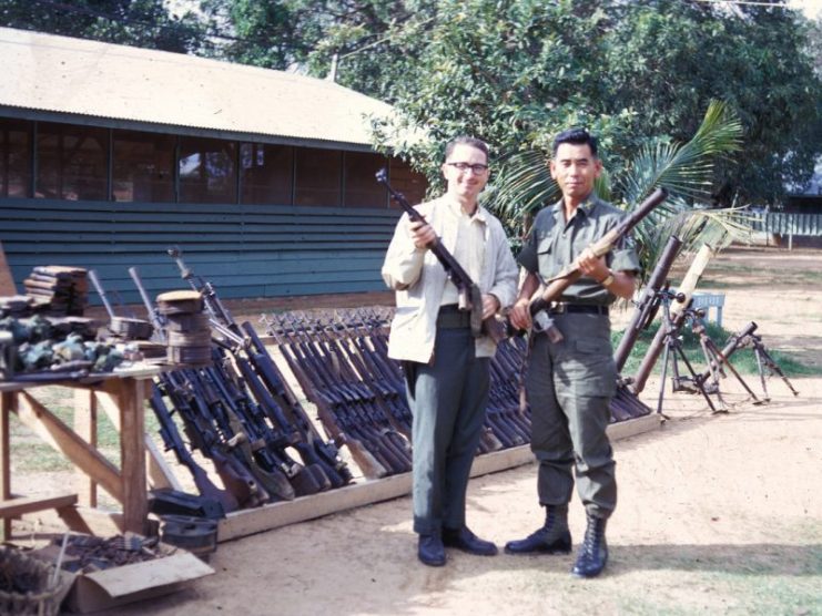 OSI activities in Vietnam included cooperating with Korean troops, who were responsible for ground security at Phu Cat Air Base. Here, an OSI agent poses with the Korean commander and a cache of captured Vietnamese weapons. The Koreans displayed the weapons to show the local population that they were succeeding against communist forces. (U.S. Air Force photo)