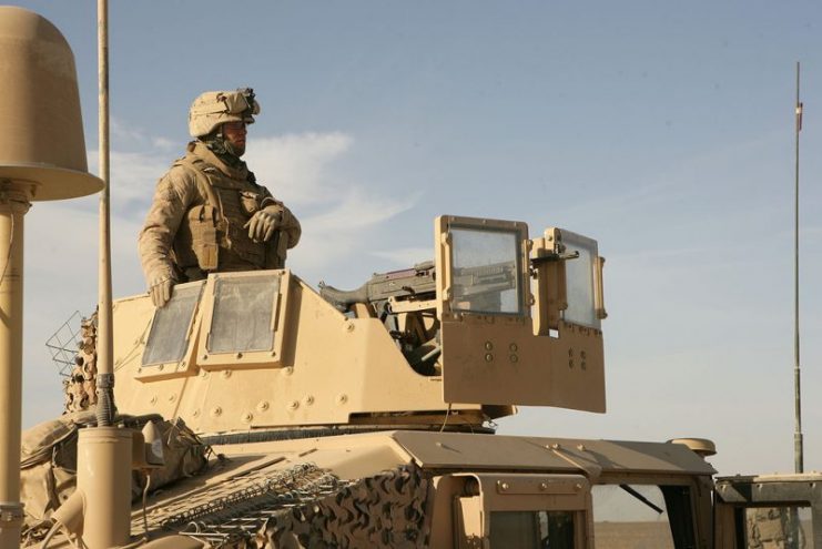 U.S. Marine Corps Lance Cpl. Jesse Young, with Company I, 3rd Battalion, 8th Marine Regiment, maintains security from his Humvee turret during a mounted patrol to a bazaar in Farah province, Afghanistan