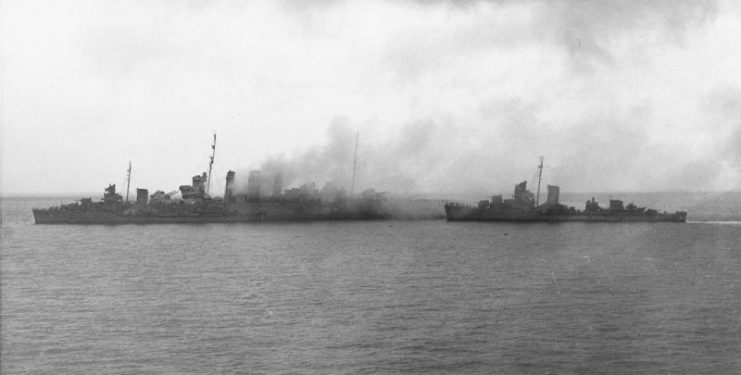 U.S. destroyers Blue and Patterson evacuate the crew from the burning Canberra