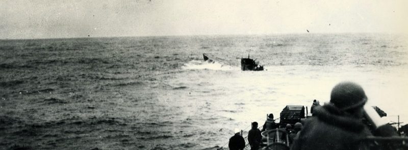 Sinking of German U-boats, 1944. German (Type IXC) U-boat, U-550, surfaces astern of USS Joyce (DE 317) after being depth charged, April 16, 1944. Joyce had a Coast Guard crew. U.S. Coast Guard photograph