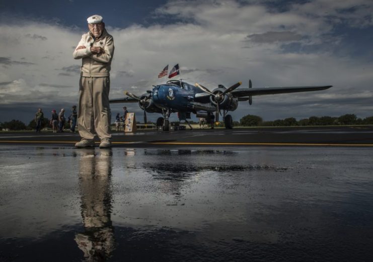 U.S. Air Force Retired Lt. Col. Richard E. Cole, Co-Pilot to Jimmy Doolittle during the Doolittle Raid, stands in front of a refurbished U.S. Navy B-25 Mitchell displayed at an airshow in Burnet, Texas. USAF photo // Staff Sgt. Vernon Young Jr.