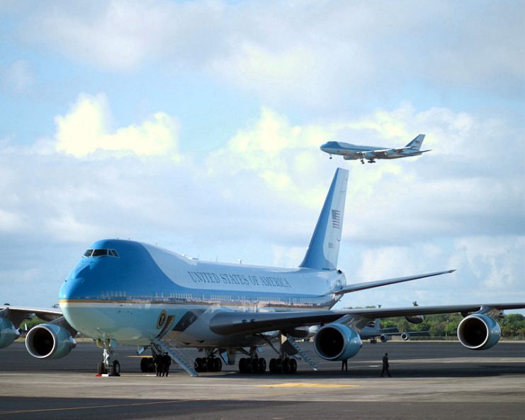 SAM 28000 sits on the ramp as Air Force One (SAM 29000 in the background) descends on final approach into Hickam Field in Honolulu, Hawaii with President George W. Bush aboard.
