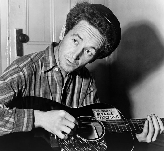 Woody Guthrie, an American singer-songwriter and folk musician well known for his protest songs.