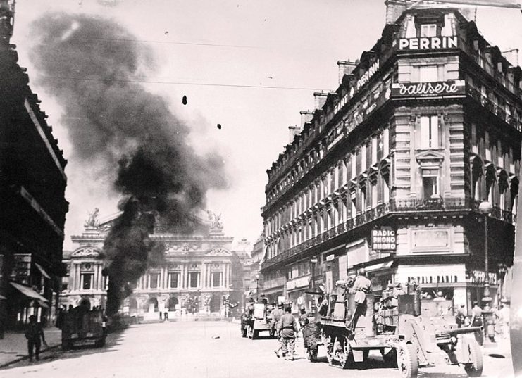 August 25 – Armoured vehicles of the 2nd Armored (Leclerc) Division fighting before the Palais Garnier. One German tank is going up in flames