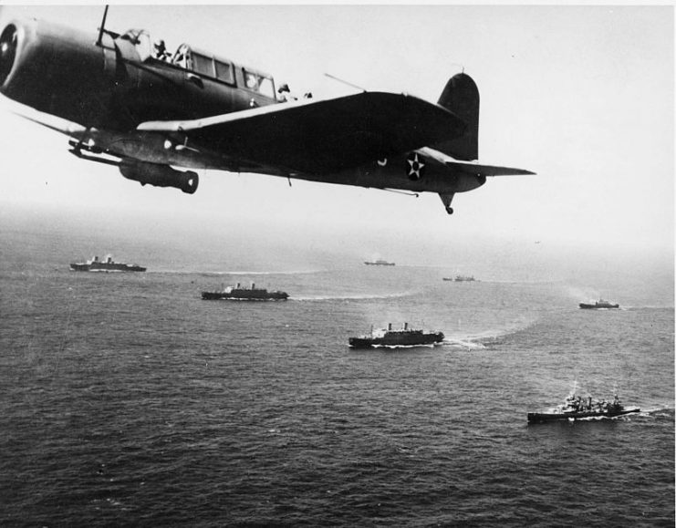 A SB2U Vindicator scout bomber from USS Ranger flies anti-submarine patrol over Convoy WS-12, en route to Cape Town, November 27, 1941. The convoy was one of many escorted by the US Navy on “Neutrality Patrol”, before the US officially entered the war.