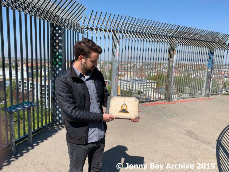 Jonny Bay holds the album in his hands on the ruins of the former flak Tower at Humboldthain in April 2019. Over 74 years later, he is retracing the steps taken by Bärwolf. Source © Jonny Bay Archive 2019