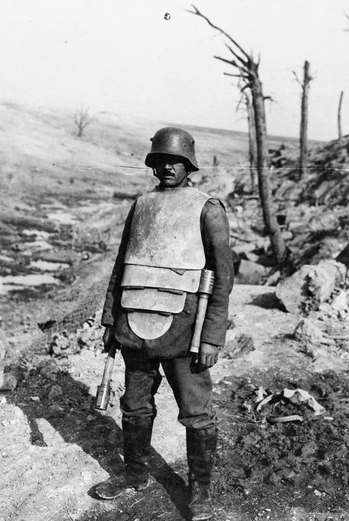 A German stormtrooper on the Somme wearing a body armour. Note two potato mashers-grenades he is armed with.