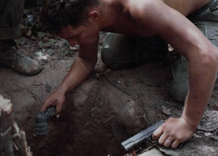 An example of not following the proper trigger discipline (the soldier’s finger is on the trigger); the pistol could also be pointed in the direction of non-targets. Vietnam War, 1967.