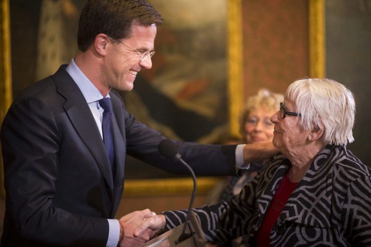 Dutch Prime Minister Mark Rutte congratulates Truus Menger-Oversteegen with her award