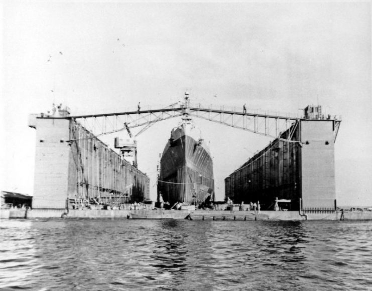 The U.S. Navy light cruiser USS Columbia (CL-56) docked in the floating dry dock USS Artisan (ABSD-1) at Espiritu Santo, New Hebrides, in January 1944.