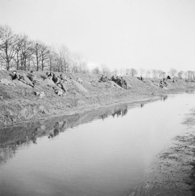 British glider troops of the 1st Battalion, Royal Ulster Rifles digging in on the banks of the River Issel, Germany, after landing, March 1945.