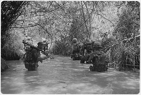 Marines of Company H, 2nd Battalion, 4th Marine Regiment take to the water as they move to join up with other elements of their battalion.