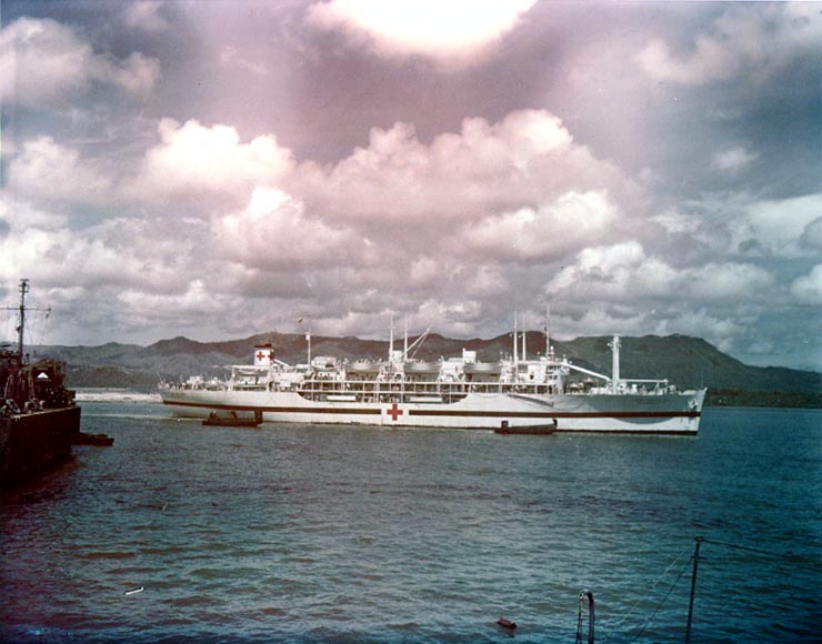 The U.S. Navy hospital ship USS Tranquillity (AH-14) arrives at Guam, carrying survivors of the heavy cruiser USS Indianapolis (CA-35), 8 August 1945.