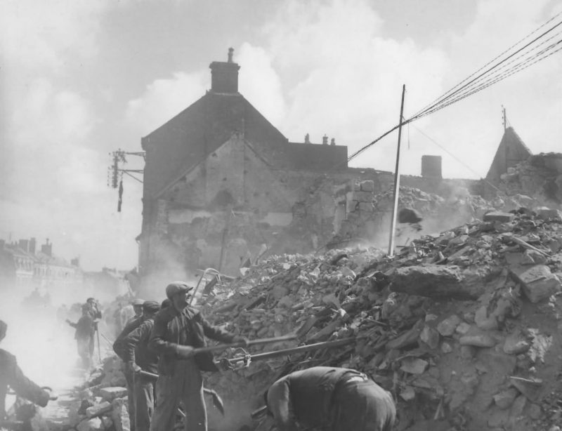 French_Refugees_Digging_Through_Rubble_Isigny-sur-Mer_Normandy_June_1944