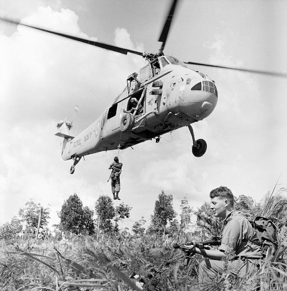 Taken in August 1964 during the Indonesian Confrontation, a British soldier is winched aboard a Westland Wessex HAS3 of 845 Naval Air Squadron
