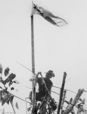 https://en.wikipedia.org/wiki/Tom_Derrick Taken on 25 November 1943, this pictures shows Sergeant Derrick hoisting the Australian flag over Sattleberg
