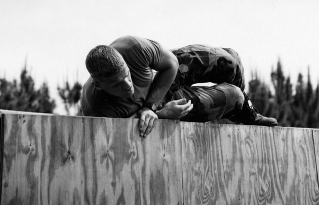 Recruit Jason Dunham scaling an obstacle in basic training via commons.wikimedia.org
