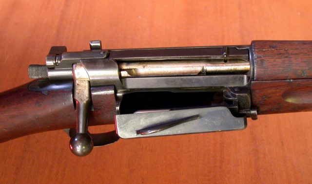 Close-up of an open American 1896 Springfield Krag magazine loading gate.