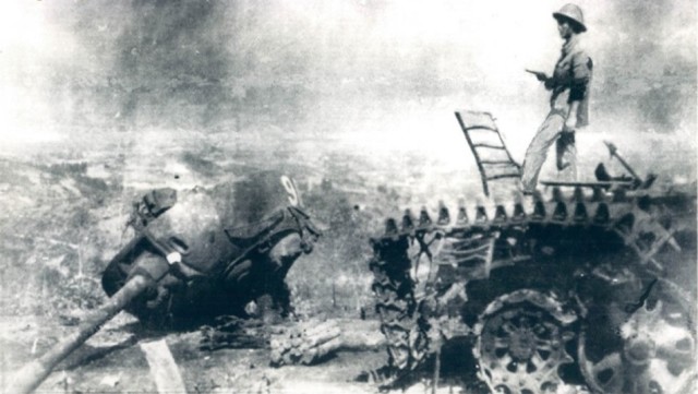 A VPA officer standing on the ruins of a Chinese tank in Cao Bằng on 7 March 1979