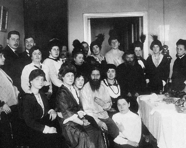 Rasputin (middle) posing with his followers and clients at his salon in 1914