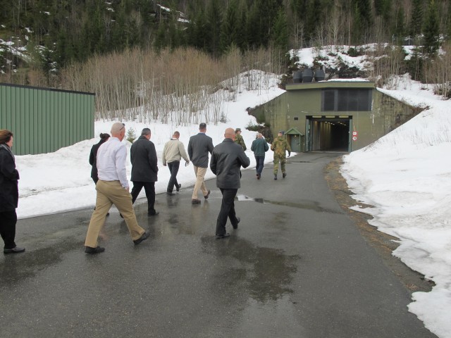 Members of the Norwegian Armed Forces give 1st Marine Logistics Group Marines a tour of one of the six storage caves located in Norway as part of the Marine Corps Prepositioning Program-Norway, April 7. The caves provide more than 25 acres of storage for trucks, ammunition and other equipment.